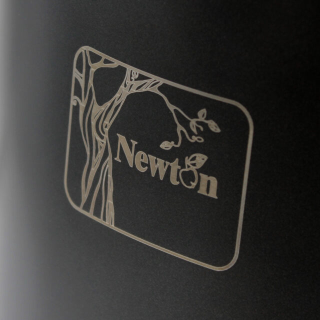 Close-up of the Newton logo on a water filter system.