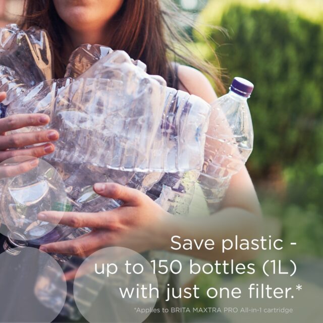 Person holding multiple plastic water bottles to illustrate plastic waste reduction.