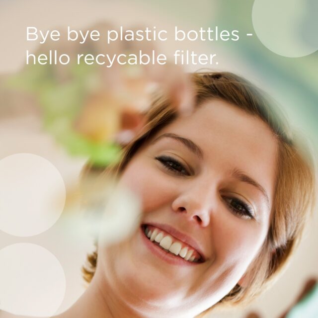 Woman smiling while holding a water filter jug