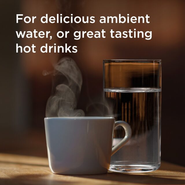 Hot water cup and glass of water on a wooden surface