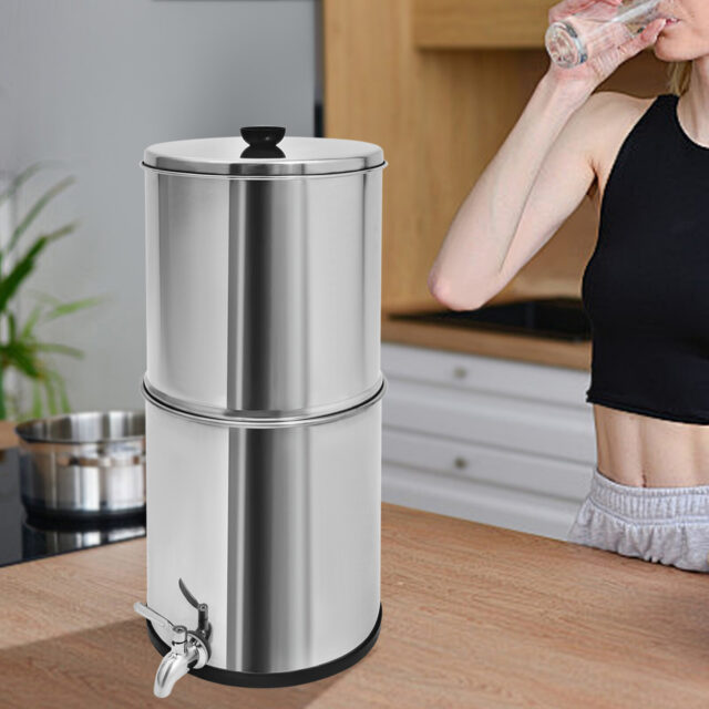 Stainless steel gravity-fed water filter system on a kitchen counter